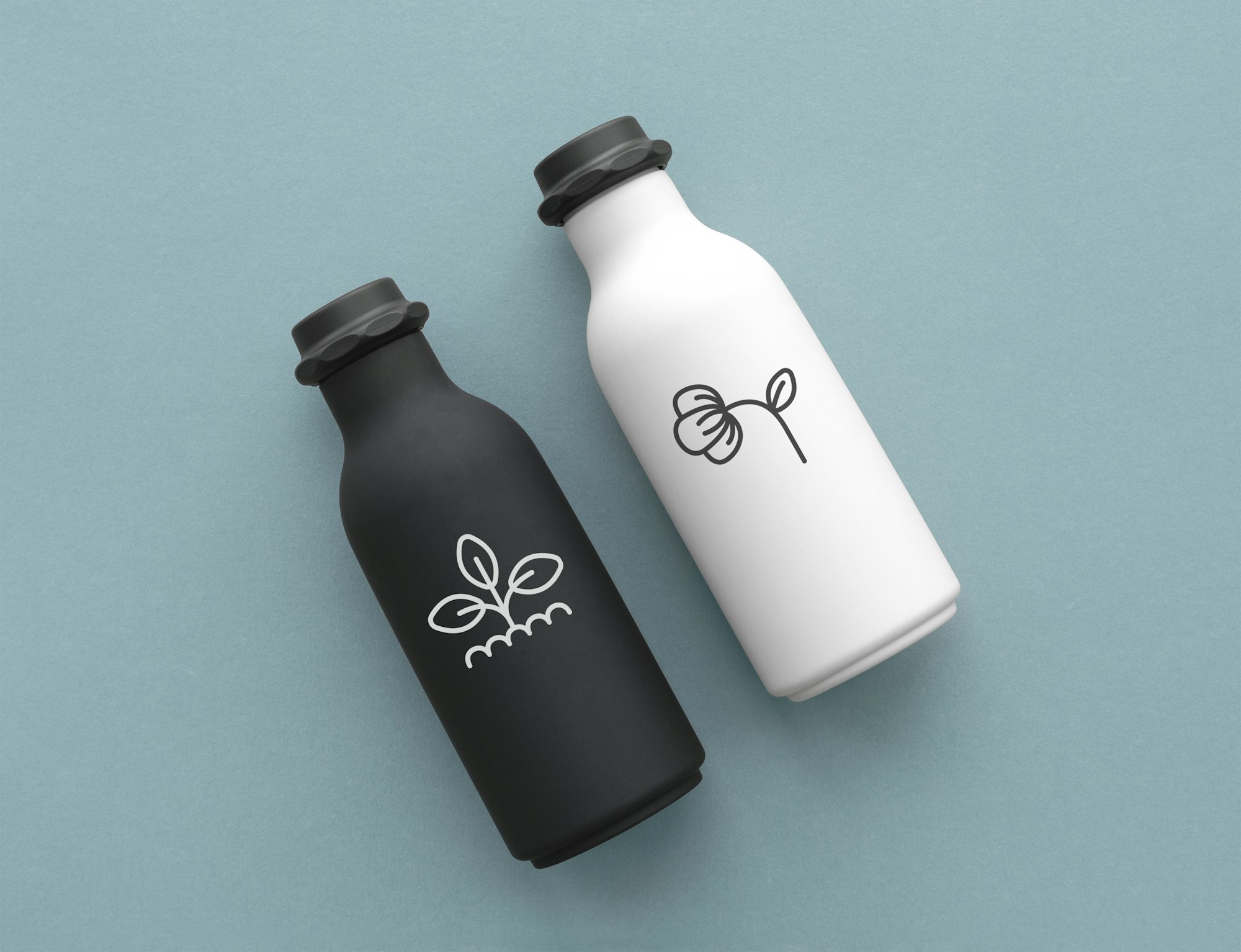 reusable water bottles with minimal logo in black and white flat lay