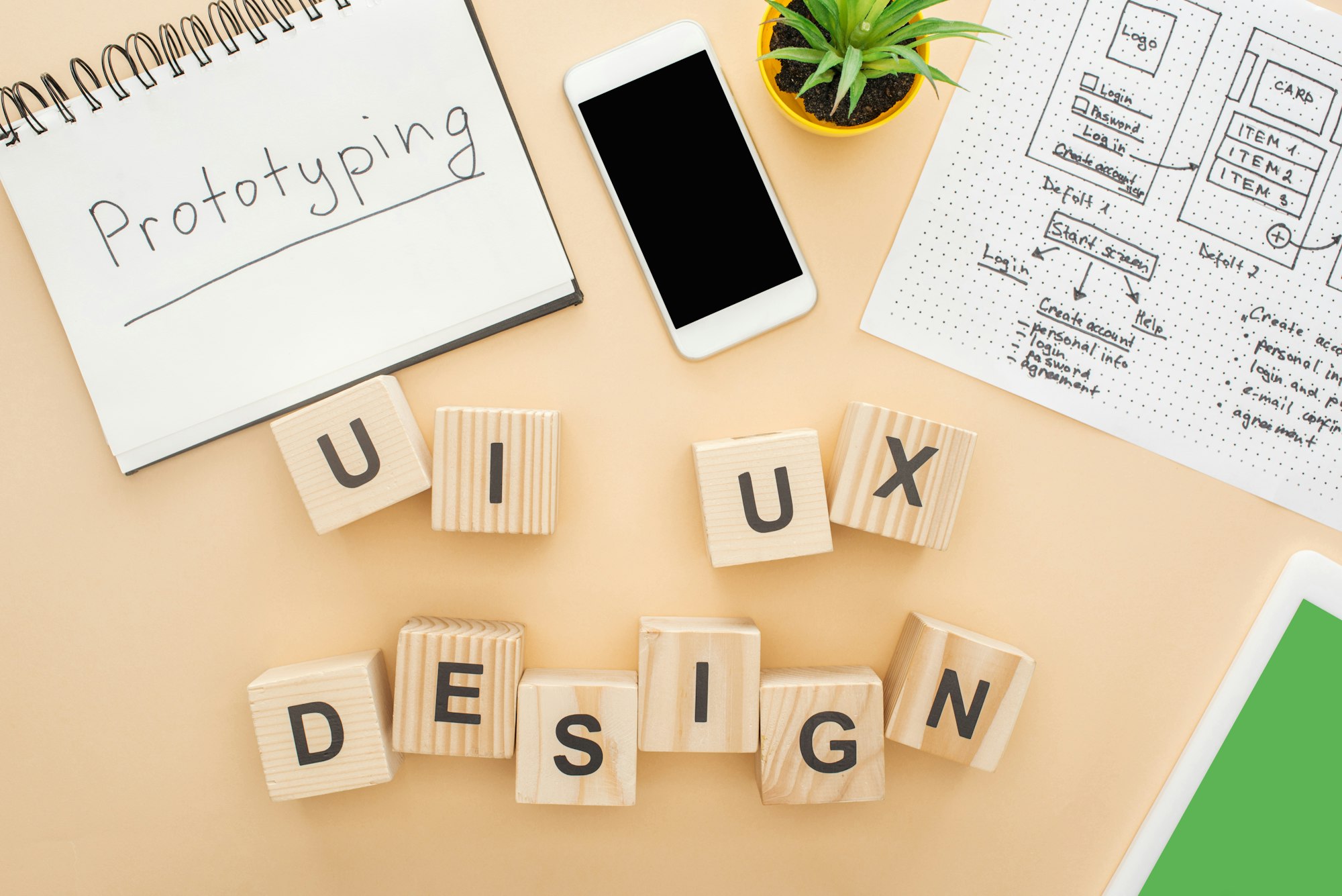 top view of gadgets near wooden blocks with ui and ux design lettering website design template